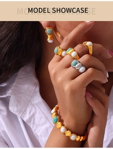 Model wearing vintage gold plated titanium steel jewelry set with oval green natural stones