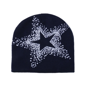 Detailed knit texture of navy beanie with white pixelated star pattern in street style