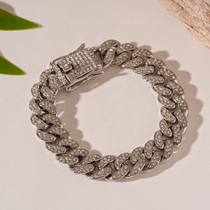 Close-up of silver-tone iced out Cuban chain bracelet with pave rhinestones