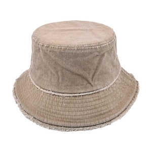 Macro detail of frayed edges on a vintage washed khaki denim bucket hat