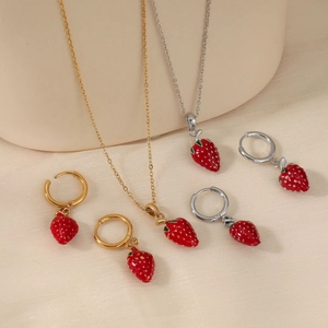 Sweet strawberry jewelry set with gold and silver necklaces and matching earrings
