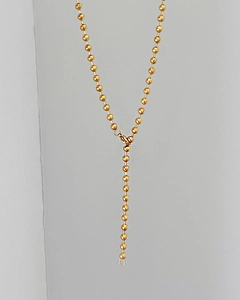 Detail of a minimalist gold beaded necklace showing polished round beads and a sturdy metal clasp