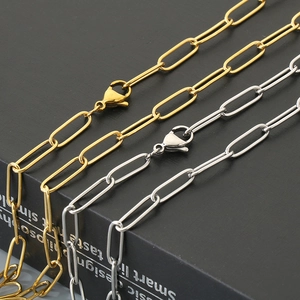 Macro shot of gold and silver stainless steel paperclip chain necklaces with lobster clasps