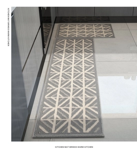 Detailed weave of grey and beige geometric kitchen mat with non-slip texture