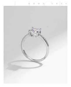Macro detail of s925 silver cushion cut ring with pavé diamonds and 4-prong setting