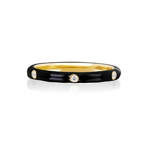 Detail of 18K gold plated ring with black enamel finish and three inset zircon stones