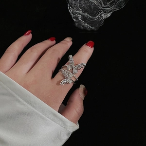 Elegant silver double butterfly ring with sparkling zircons shown on a black background