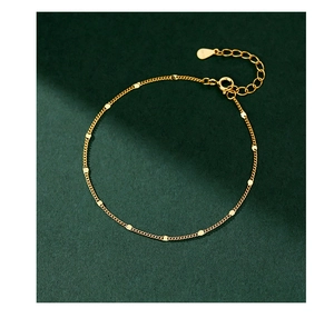Detail of S925 sterling silver chain bracelet featuring gold disc charms and clasp