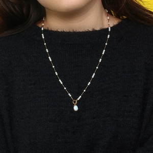 Detail of 18K gold-plated stainless steel necklace with Baroque pearls and OT toggle buckle