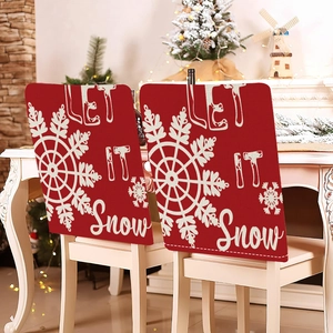 Close-up of red Christmas chair covers with white Let It Snow text and snowflake patterns