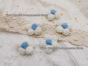 Detail view of five handcrafted crochet milk cotton flowers in white and blue for DIY projects