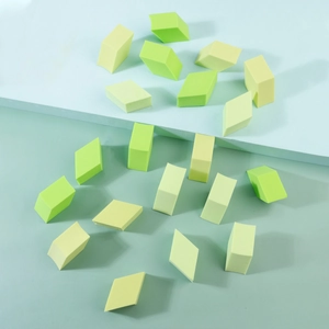 Macro shot of 20 non-latex diamond-shaped makeup sponges in fresh green and yellow colors