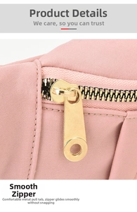 Close-up of smooth golden metal zipper and pink fabric texture on a sports crossbody bag