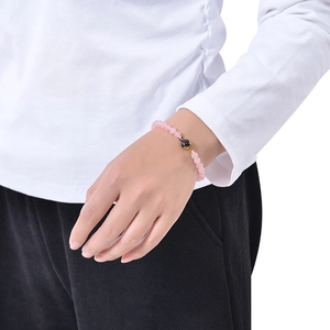 Fashionable 6mm pink tiger eye stone bracelet with black projection bead on a wrist