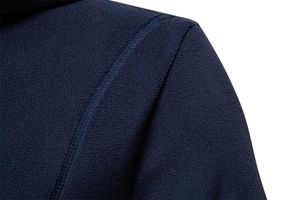 Detailed view of stitching and navy blue fleece fabric texture on men's hoodie shoulder