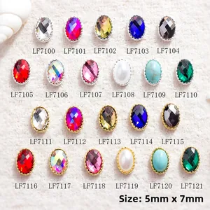 Macro shot of 5x7mm oval nail gems with gold and silver borders in multiple colors