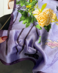 Close-up of purple silk scarf featuring yellow peonies and pink cloud pattern details