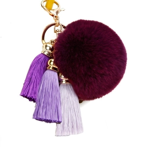 Deep purple faux fur pompom keychain with gradient purple tassels and gold hardware