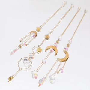 Detailed close-up of gold celestial sun moon and star AB iridescent crystal suncatchers