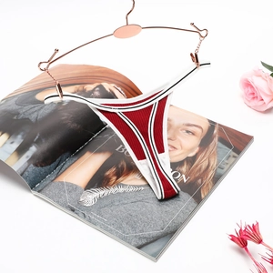 Detail of red ribbed cotton thong with contrast striped waistband on rose gold hanger