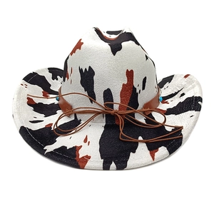 Western cowboy hat with cow print, faux suede material and brown leather strap