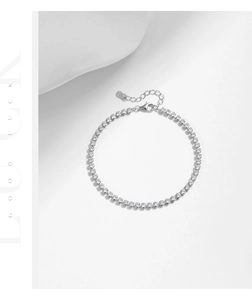 Detail showing the S925 sterling silver lobster clasp and heart tag on a tennis bracelet