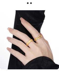 Macro shot of irregular gold rings with textured molten finish and micro-inlaid zircons