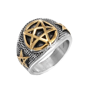 Detail of vintage punk ring with golden star emblem and honeycomb texture on silver band