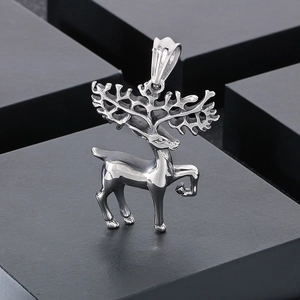 Polished silver stainless steel stag pendant with intricate antlers on dark background
