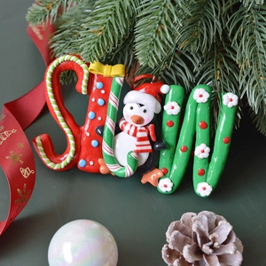 Christmas SNOW clay ornament with candy cane stripes and a cute penguin decoration