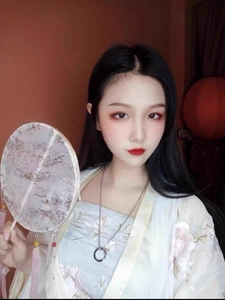 Close-up of a silver Mobius ring pendant necklace paired with traditional Hanfu dress