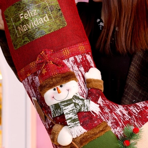 Close-up of a red burlap Christmas stocking with a 3D snowman and Feliz Navidad text
