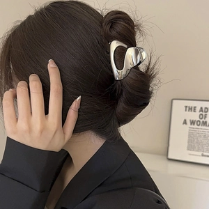 Minimalist silver metal hair claw clip for thick hair shown on a woman from behind