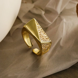 Luxury gold-plated open ring with geometric zircon inlay on a soft beige background