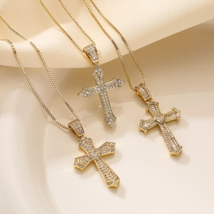 Detailed close-up of 18K gold plated cross necklaces with sparkling heart-shaped zircon