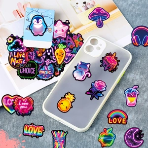 Close-up of cool neon waterproof stickers on a laptop surface for creative decoration