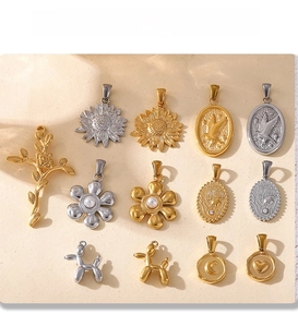 Detail of PVD electroplated 18K gold and silver pendants in floral and geometric shapes