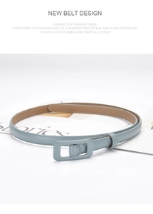 Detail of light blue leather belt with matching rectangular buckle on white surface