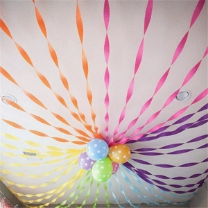 Rainbow crepe paper streamers and polka dot balloons for vibrant party ceiling decoration