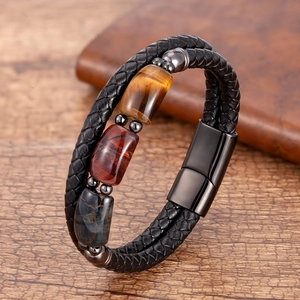 Detail of men's leather braided bracelet with tiger eye beads and black magnetic clasp