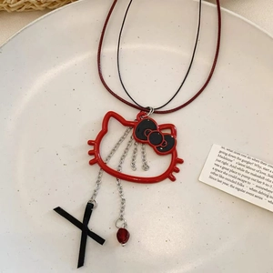 Macro view of a red cat outline necklace with black bow and heart bead charms