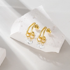 Detailed macro view of S925 sterling silver gold earrings featuring double round zircons