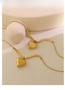 Detail of 18K gold-plated snake chain necklaces with 3D heart-shaped pendants