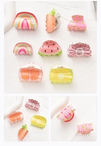 Detail showing colorful acrylic mini hair clips in fruit shapes like watermelon and orange