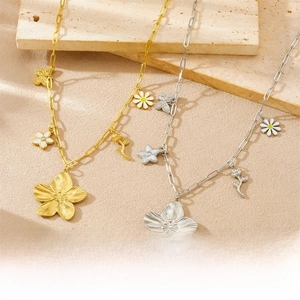 Detail of gold and silver paperclip necklaces with floral and butterfly pendants