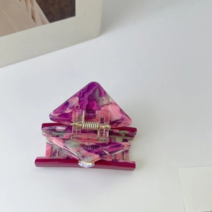 Macro shot of marble textured acetate hair claw clip with purple and pink resin patterns