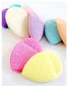 Detailed macro view of heart-shaped multi-colored porous cleansing sponges for face