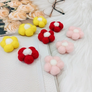 Handmade wool felt flowers in red yellow and pink for DIY crafts and accessories