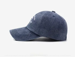 Detail of dark blue denim baseball cap with vintage white embroidery and washed texture