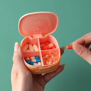 Portable four-compartment mini pill box in orange with silicone seal for travel use
